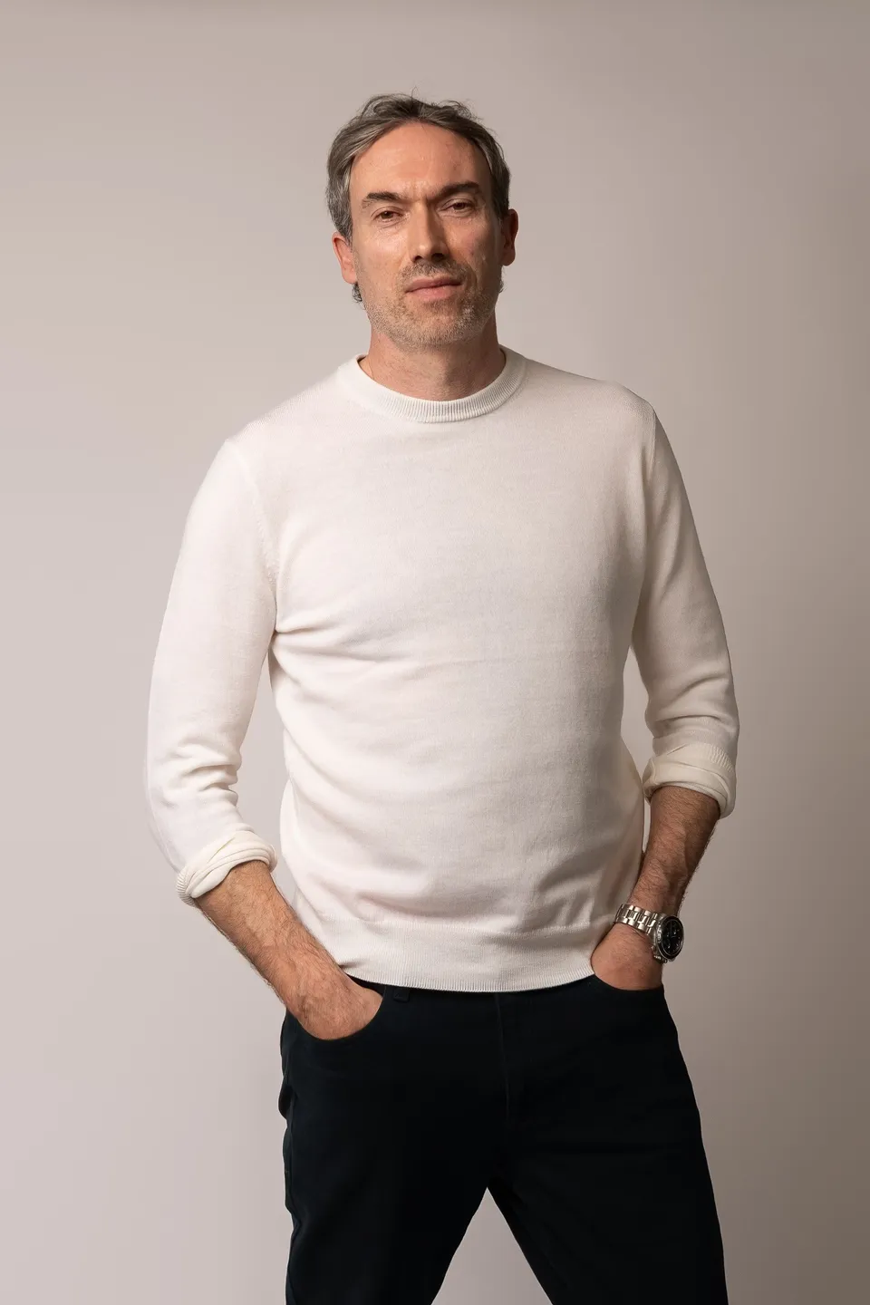 Kieron C, white jumper, hands in pockets