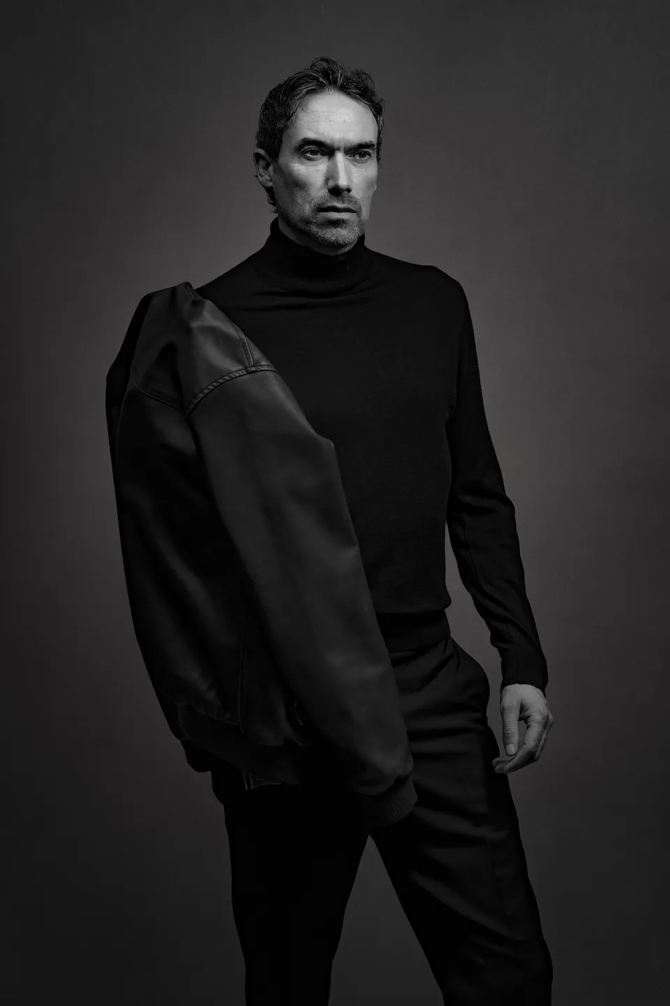 Kieron C, black and white, jacket over shoulder